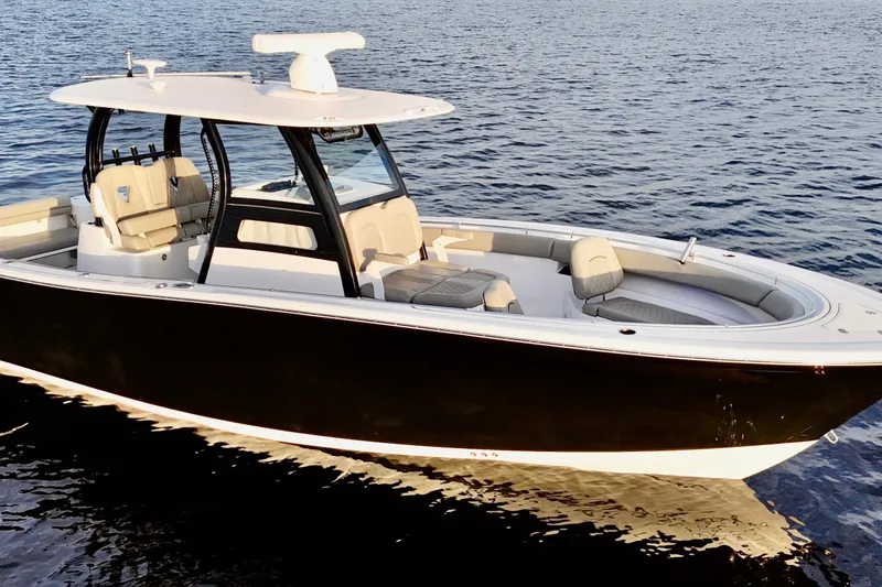The Image of 2022 Sportsman Open 322 Center Console boat on calm water. - 0