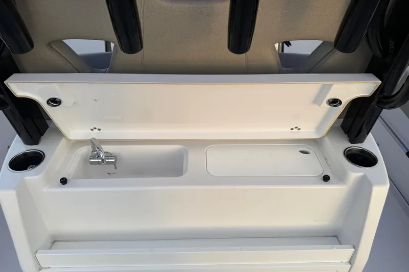 Slide: The Image of 2022 Sportsman Open 322 Center Console boat sink and storage area. - 17