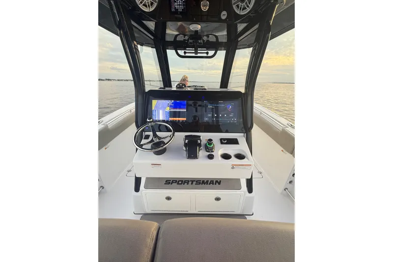 Slide: The Image of 2022 Sportsman Open 322 Center Console boat dashboard with steering wheel and navigation display. - 20