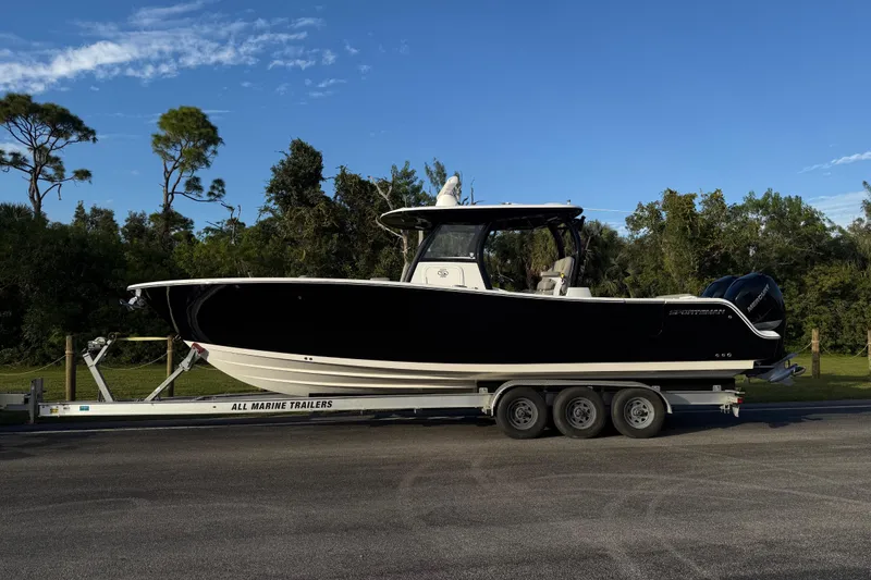 Slide: The Image of 2022 Sportsman Open 322 Center Console boat on trailer, parked outdoors. - 24