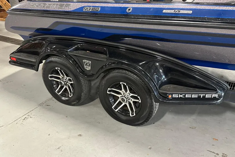 Slide: The Image of 2016 Skeeter FX20 Limited Edition boat trailer with dual wheels and sleek design. - 4