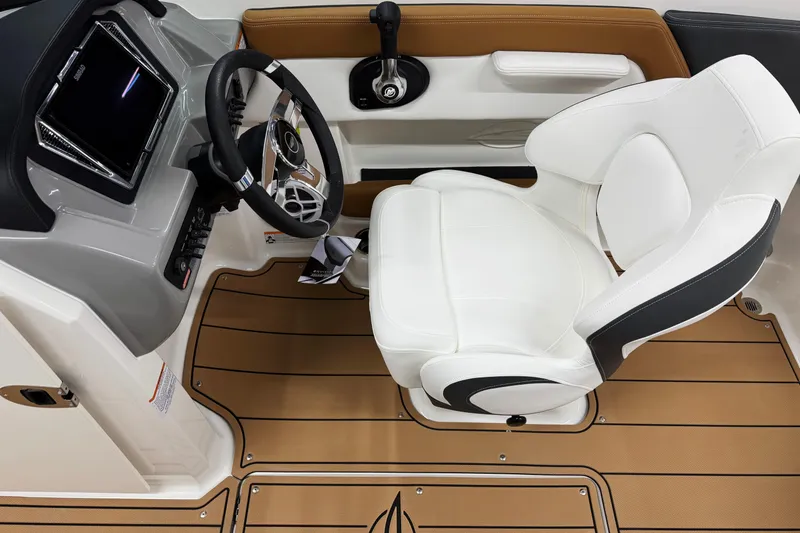 Slide: The Image of 2026 Chaparral 21 SSi boat interior with white captain's seat and modern dashboard. - 13