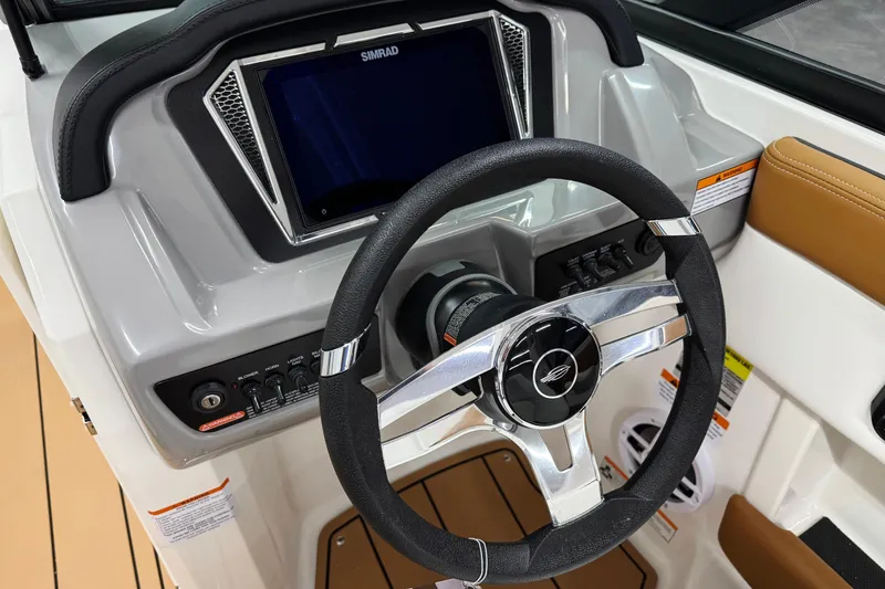 Slide: The Image of 2026 Chaparral 21 SSi boat dashboard with steering wheel and control panel. - 14
