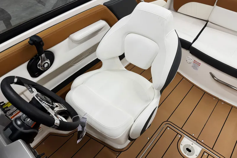 Slide: The Image of 2026 Chaparral 21 SSi boat interior with white captain's chair and steering wheel. - 15