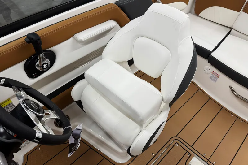Slide: The Image of 2026 Chaparral 21 SSi boat interior with white captain's chair and steering wheel. - 16