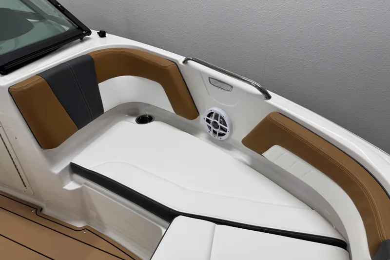 Slide: The Image of 2026 Chaparral 21 SSi boat interior with tan and black seating, speaker, and cup holder. - 21