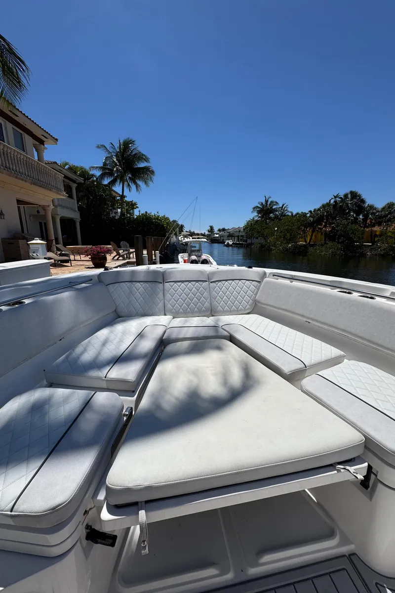 Slide: The Image of 2020 Sea Fox 368 Commander boat with spacious seating, docked near waterfront homes. - 37
