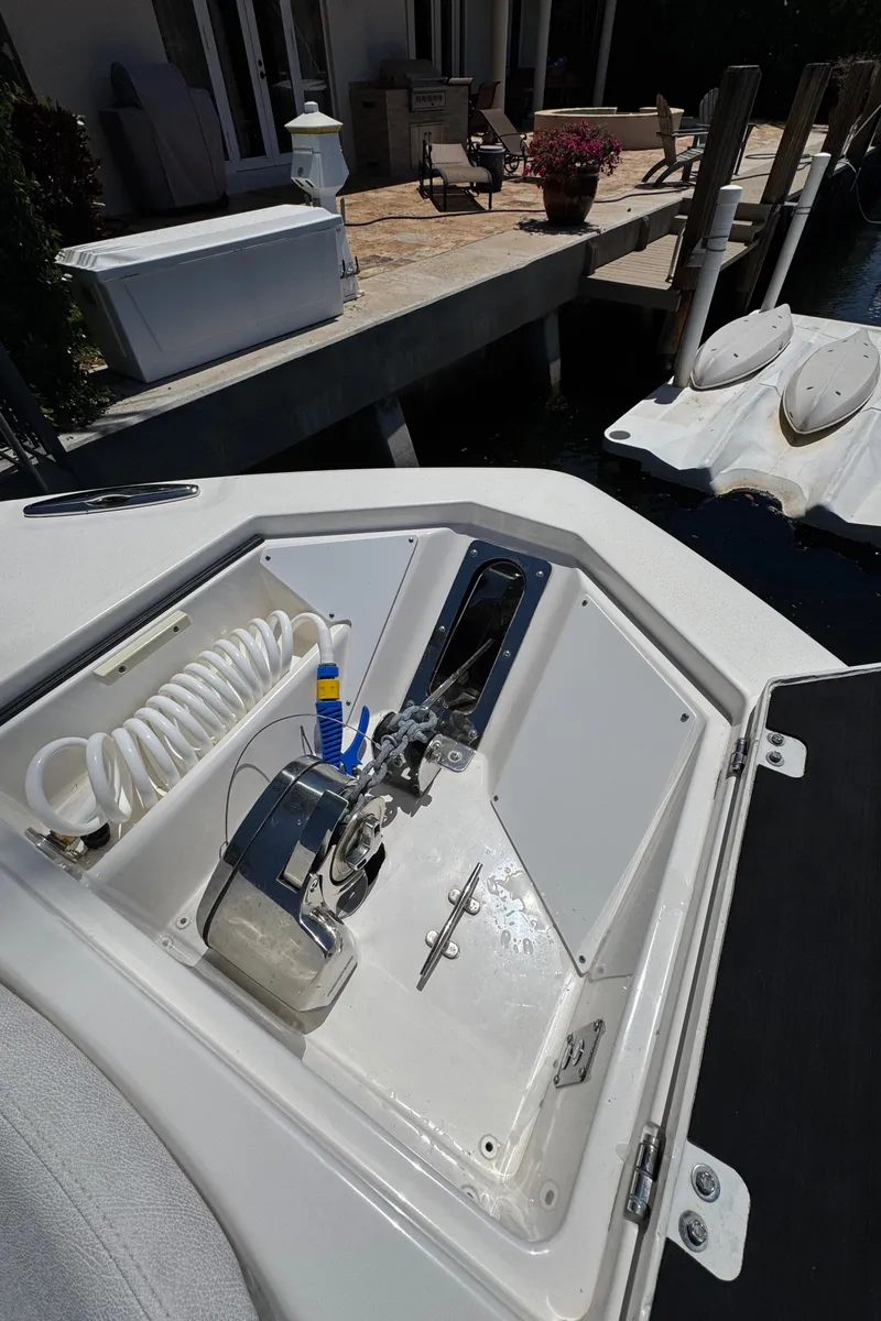Slide: The Image of 2020 Sea Fox 368 Commander boat storage compartment with coiled hose and anchor. - 39
