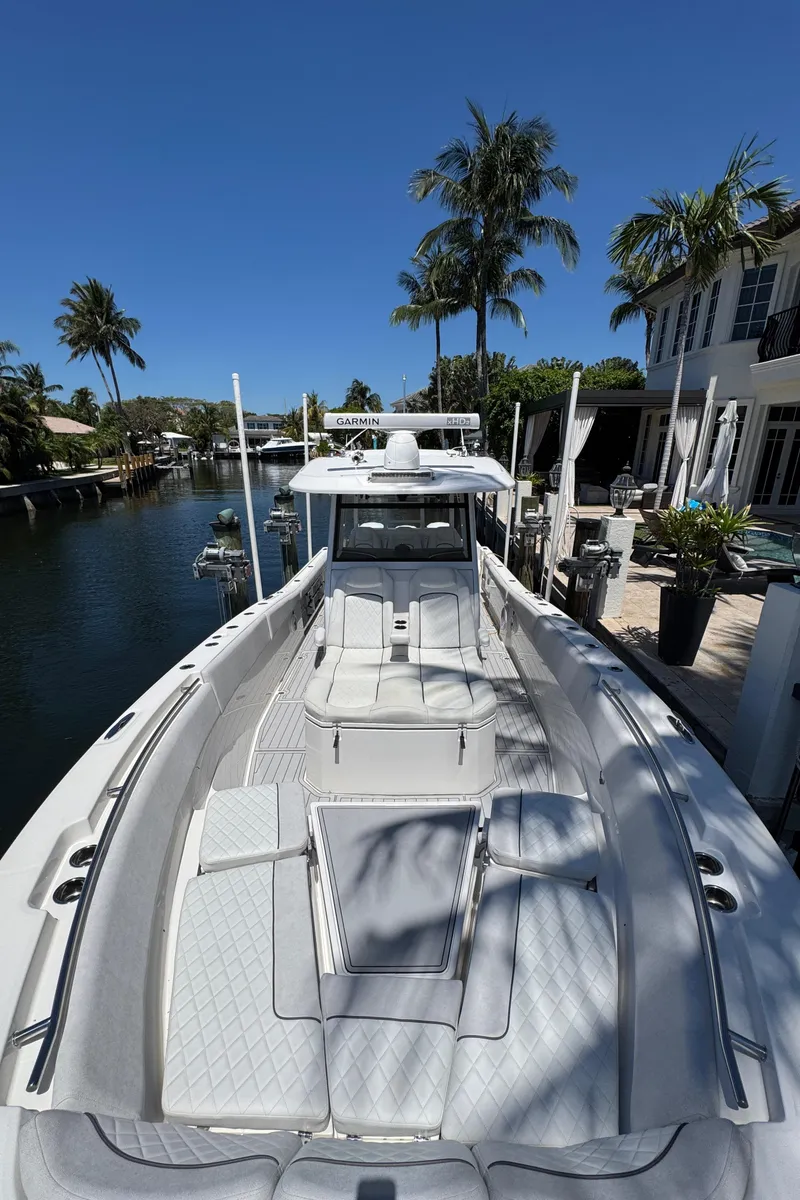 Slide: The Image of 2020 Sea Fox 368 Commander boat docked by a canal with palm trees. - 40