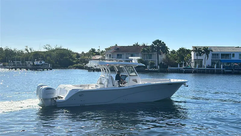 Slide: The Image of 2020 Sea Fox 368 Commander boat cruising on a sunny day near waterfront homes. - 44