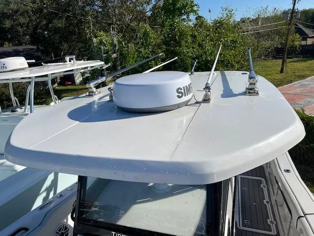 Slide: The Image of 2024 Tidewater 320 CC Adventure boat with radar equipment on the roof. - 11