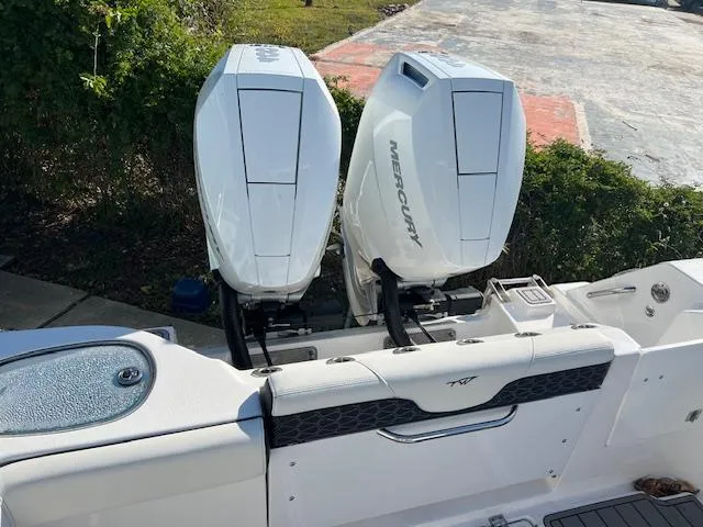 Slide: The Image of 2024 Tidewater 320 CC Adventure with dual Mercury outboard engines, rear view. - 4