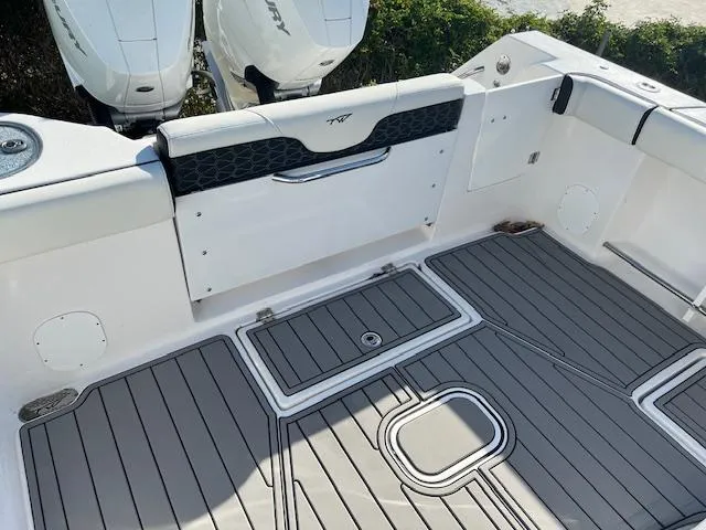Slide: The Image of 2024 Tidewater 320 CC Adventure boat deck with dual engines and sleek design. - 5