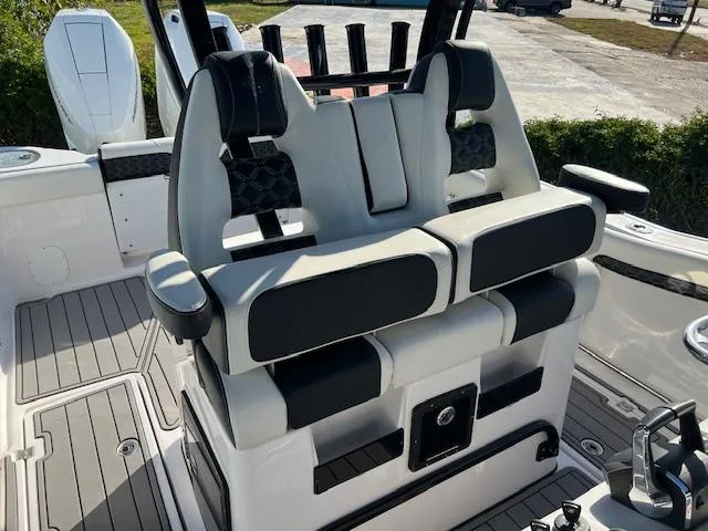 Slide: The Image of 2024 Tidewater 320 CC Adventure boat seats with sleek black and white design. - 7