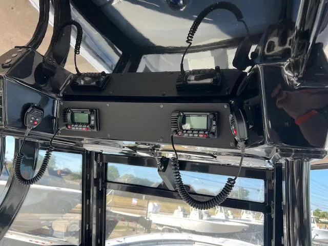 Slide: The Image of 2024 Tidewater 320 CC Adventure boat dashboard with communication equipment. - 8