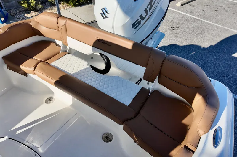Slide: The Image of 2026 Pioneer 202 Islander boat interior with brown leather seating and Suzuki engine. - 10