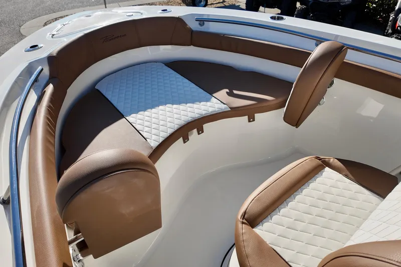 Slide: The Image of 2026 Pioneer 202 Islander boat interior with brown and white cushioned seating. - 13