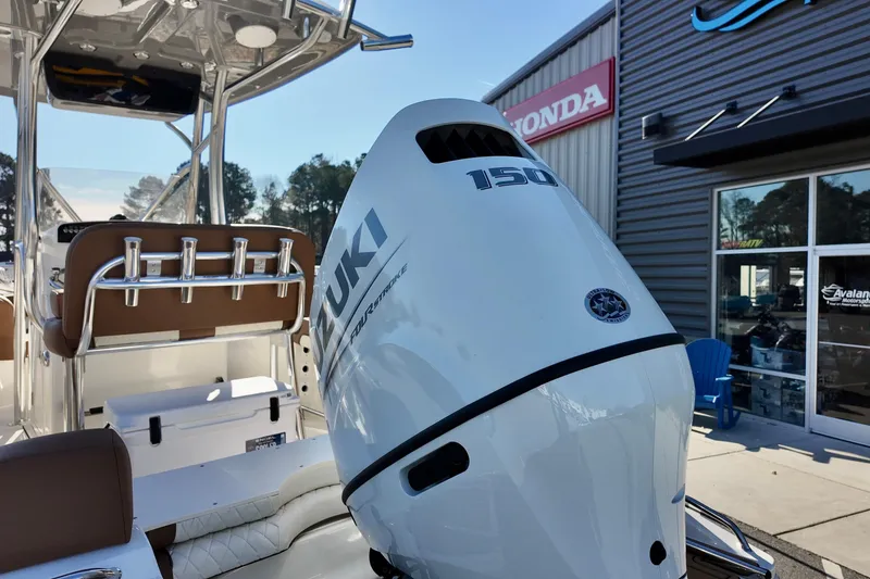 Slide: The Image of 2026 Pioneer 202 Islander boat with Suzuki 150 outboard motor at dealership. - 14