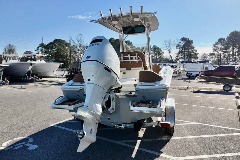 Slide: The Image of 2026 Pioneer 202 Islander boat with powerful outboard motor in a sunny marina. - 4