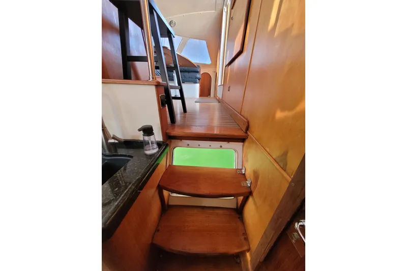 Slide: The Image of Interior of 1995 Lagoon TPI yacht with wooden stairs and modern design elements. - 10