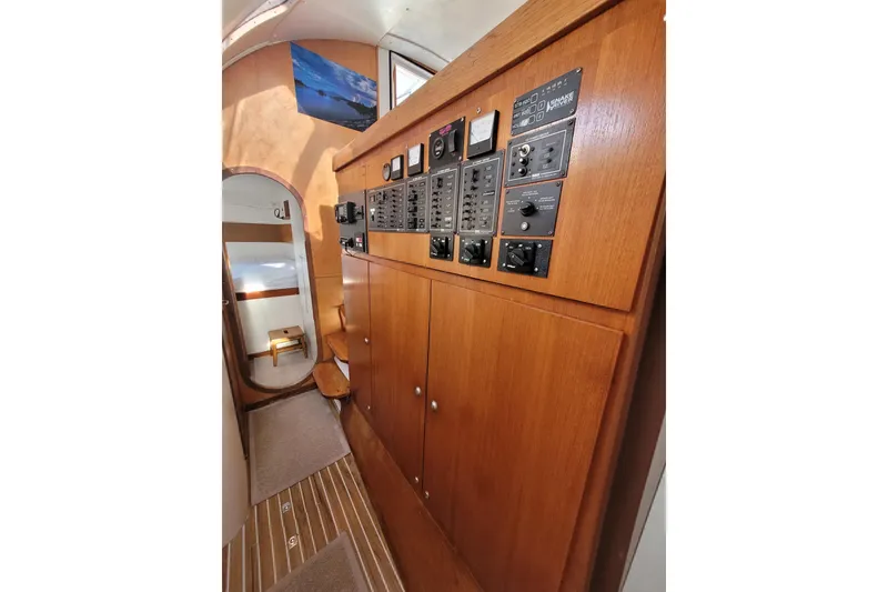 Slide: The Image of Interior of 1995 Lagoon TPI yacht with wooden paneling and control switches. - 11