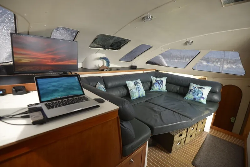 Slide: The Image of Interior of 1995 Lagoon TPI yacht with cozy seating, pillows, and work desk. - 13