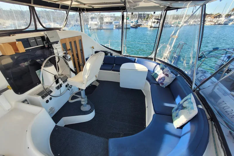 Slide: The Image of Interior of a 1995 Lagoon TPI yacht with steering wheel and blue seating. - 26