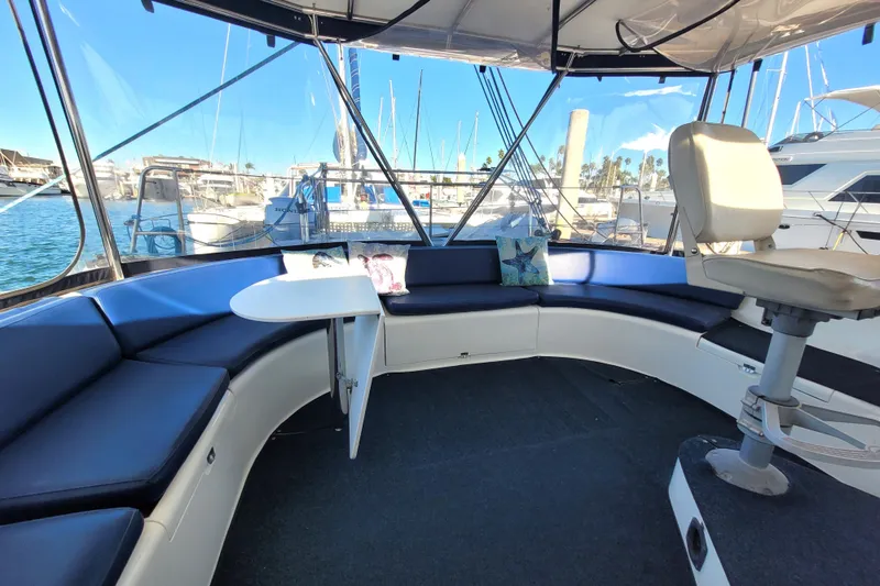 Slide: The Image of Interior of 1995 Lagoon TPI yacht with blue seating and marina view. - 3