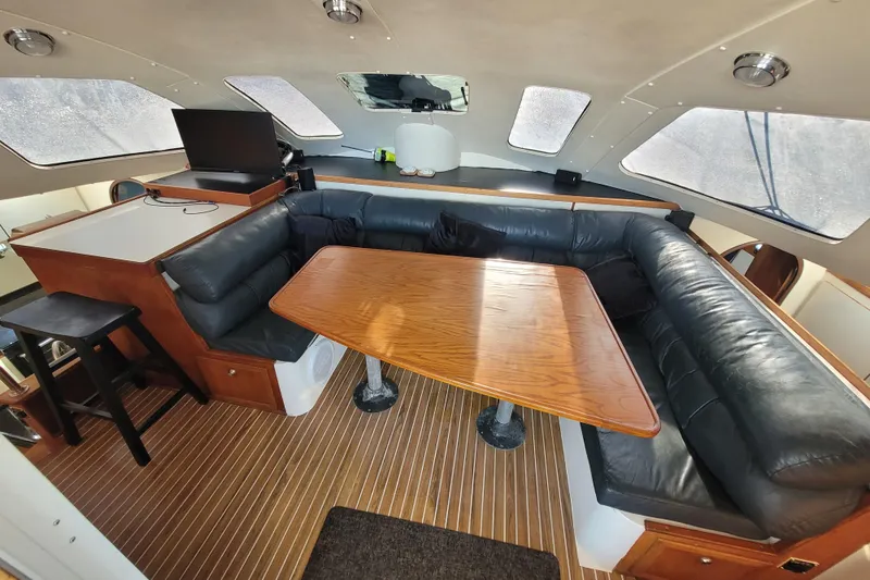 Slide: The Image of Interior of 1995 Lagoon TPI yacht with wooden table and leather seating. - 5