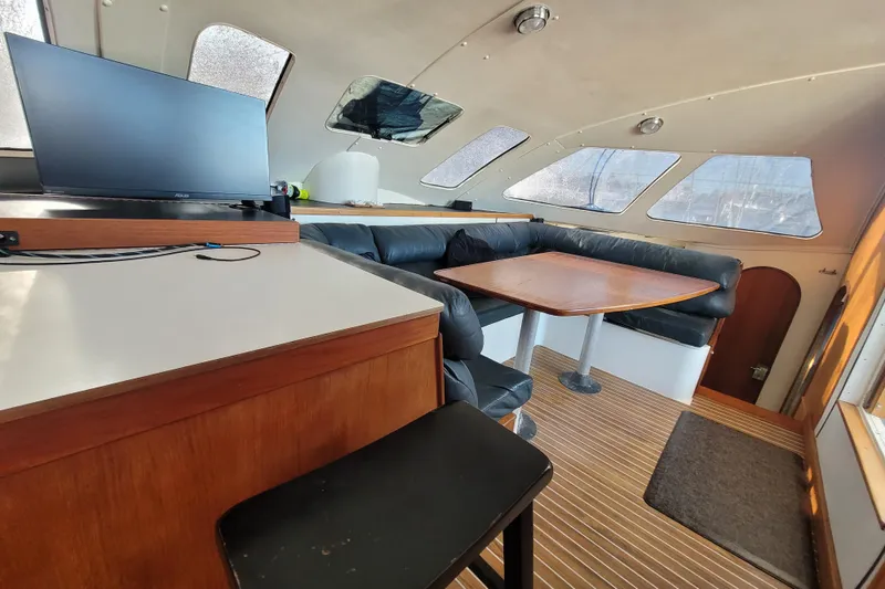 Slide: The Image of Interior of a 1995 Lagoon TPI yacht with seating and a table. - 6