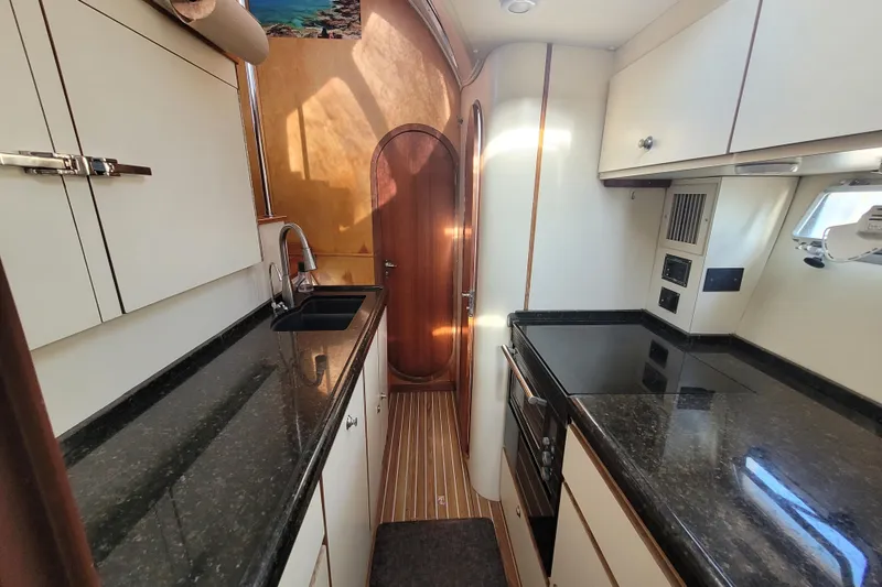 Slide: The Image of 1995 Lagoon TPI yacht kitchen with sleek countertops and modern appliances. - 7