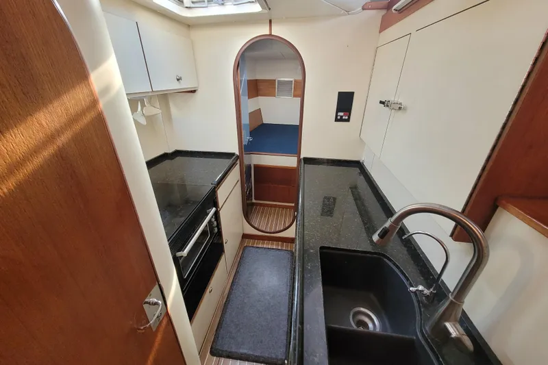 Slide: The Image of Interior of a 1995 Lagoon TPI yacht kitchen with modern amenities and sleek design. - 9