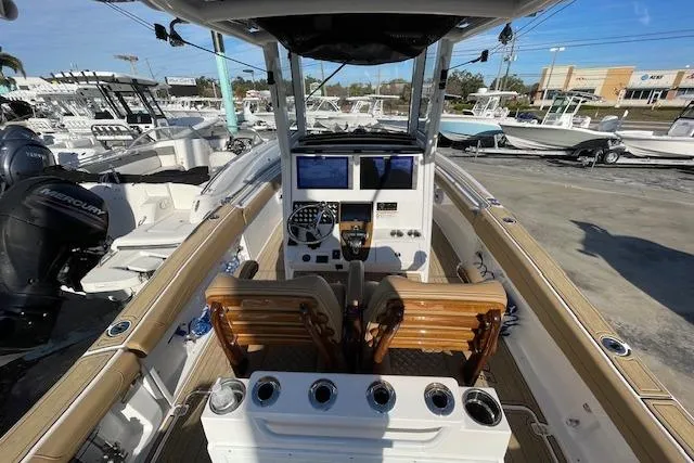 Slide: The Image of 2026 Caymas 291 HB boat interior with dual screens and wooden seating. - 10