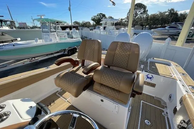 Slide: The Image of 2026 Caymas 291 HB boat interior with tan seats and steering wheel. - 12