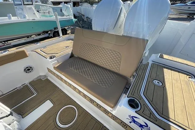 Slide: The Image of 2026 Caymas 291 HB boat interior with cushioned seating and teak-style flooring. - 2