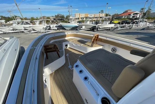 Slide: The Image of 2026 Caymas 291 HB boat interior with cushioned seating and wood accents. - 4