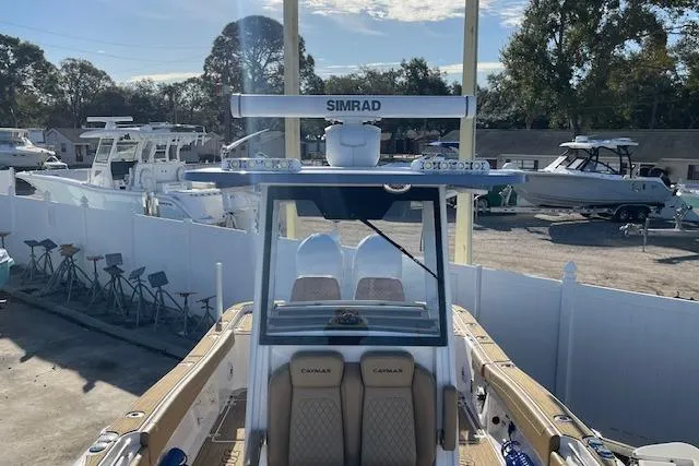 Slide: The Image of 2026 Caymas 291 HB boat with Simrad electronics, docked in a marina. - 7