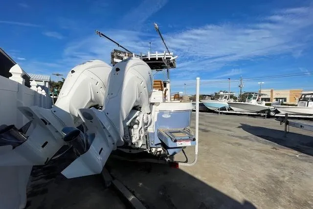 Slide: The Image of 2026 Caymas 291 HB boat with dual outboard engines in a marina setting. - 9