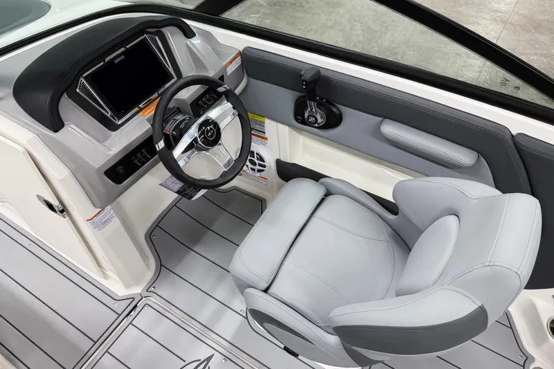Slide: The Image of 2026 Chaparral 21 SSi OB boat interior with steering wheel and captain's seat. - 14