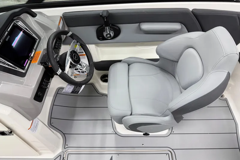 Slide: The Image of 2026 Chaparral 21 SSi OB boat interior with sleek steering and comfortable seating. - 15