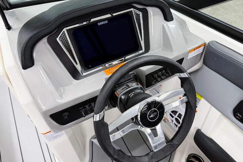 Slide: The Image of 2026 Chaparral 21 SSi OB boat dashboard with steering wheel and Simrad display. - 16