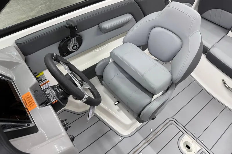 Slide: The Image of 2026 Chaparral 21 SSi OB boat interior with steering wheel and gray seating. - 19
