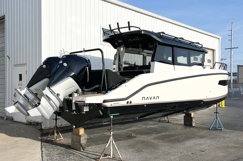 The Image of 2026 Navan C30 boat with dual outboard motors on display at a marina. - 1