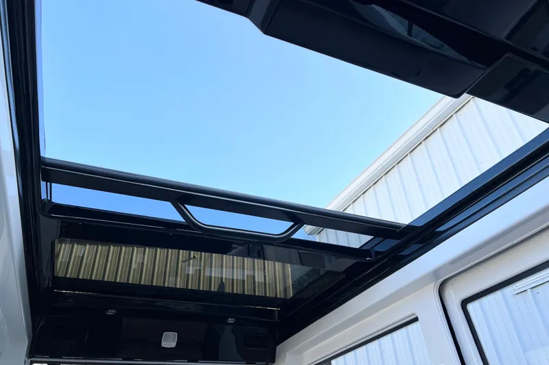 Slide: The Image of Sunroof view of 2026 Navan C30, showcasing sleek design and clear blue sky. - 23