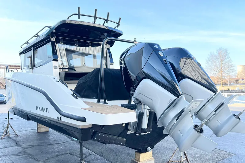 Slide: The Image of Navan C30 boat 2026 with dual outboard engines on stands. - 3