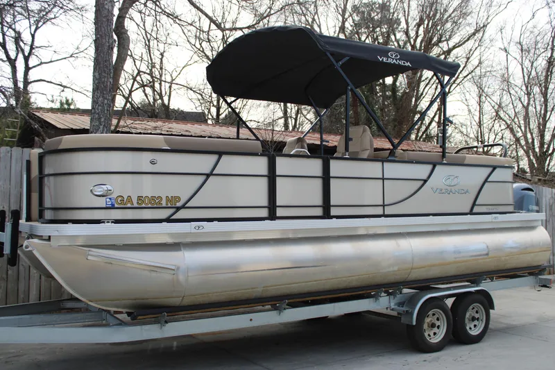 The Image of 2023 Veranda VR22RC pontoon boat on trailer, parked outdoors. - 1