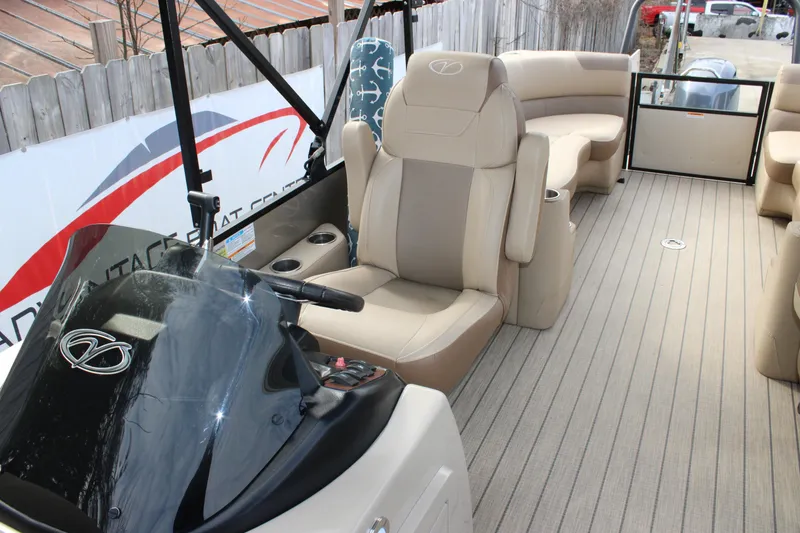 Slide: The Image of 2023 Veranda VR22RC pontoon boat interior with beige seating and steering console. - 11