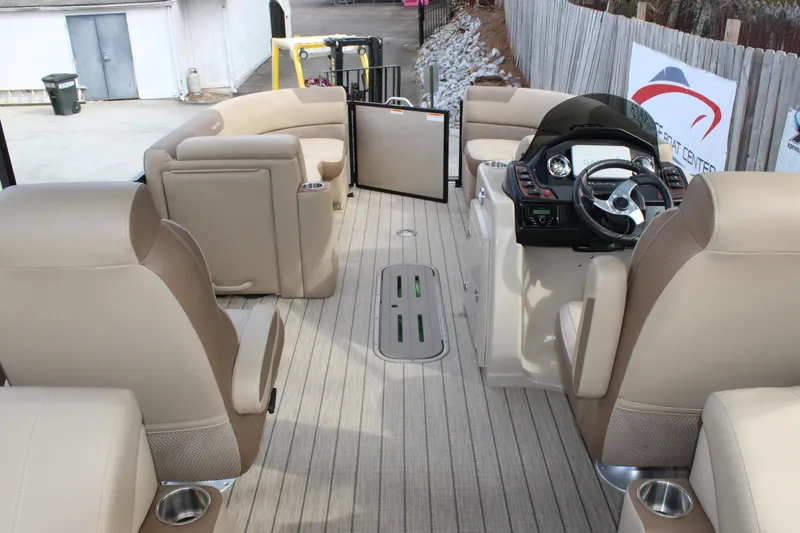 Slide: The Image of 2023 Veranda VR22RC boat interior with beige seating and modern steering console. - 13