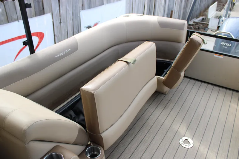 Slide: The Image of 2023 Veranda VR22RC boat interior with beige seating and cup holders. - 14