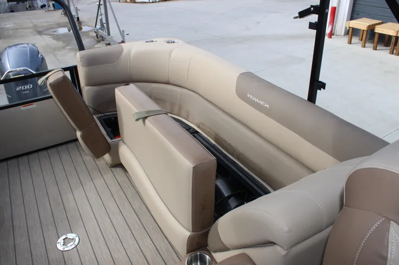 Slide: The Image of 2023 Veranda VR22RC boat interior with beige seating and storage compartments. - 15